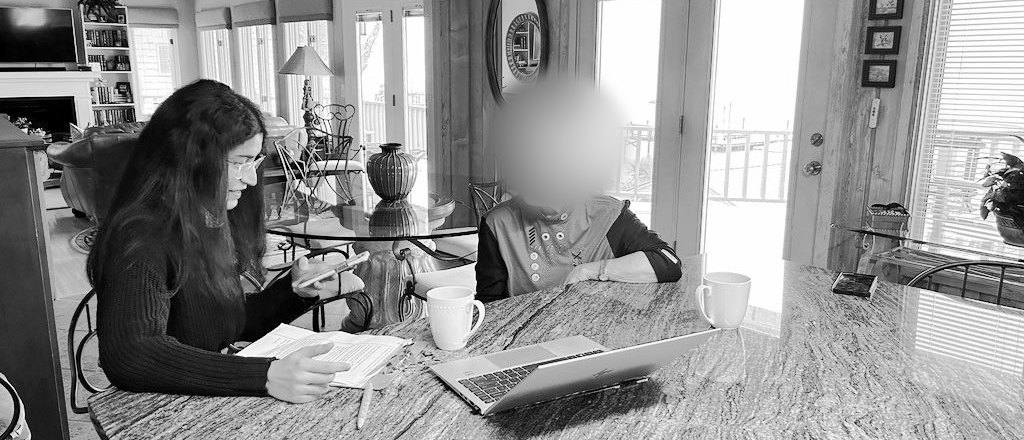 Shreya interviews a participant at her kitchen table