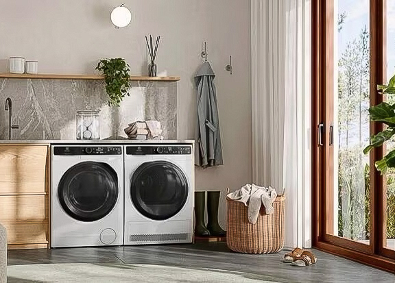 A washer and dryer side by side in a bright laundry room